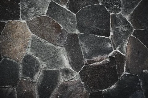 Stone wall texture background - grey stone siding with different sized stones Stock Photos