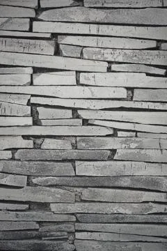 Stone wall texture background - grey stone siding with different sized stones Stock Photos