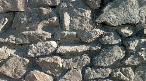 Stone wall texture background - grey stone siding with different sized stones Foto stock