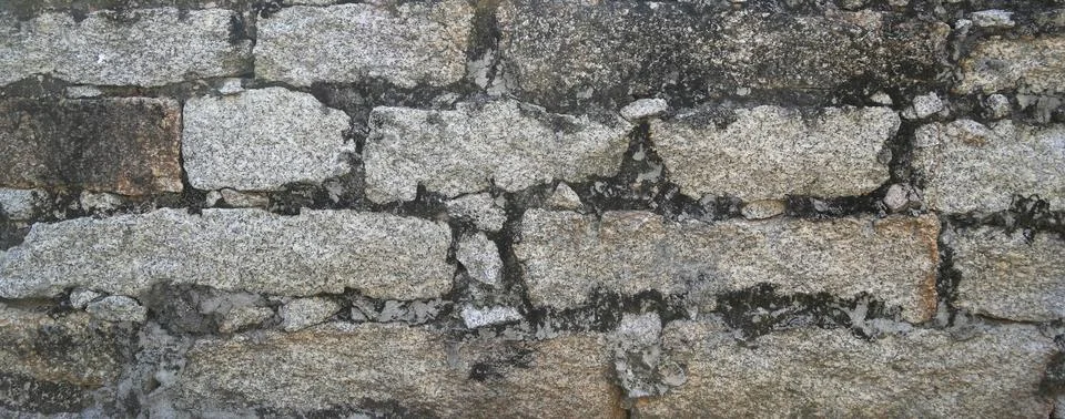 Stone wall texture background of grey brick stones. Stock Photos
