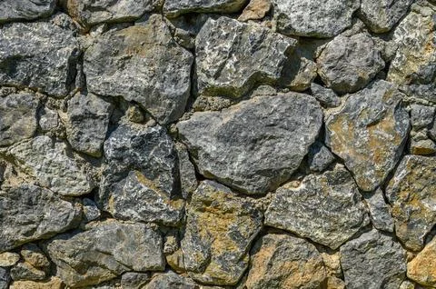 Stone wall texture background - grey stone siding with different sized stones Foto stock