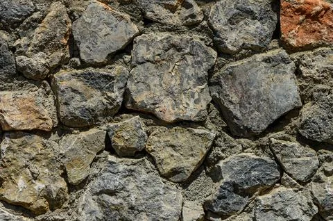 Stone wall texture background - grey stone siding with different sized stones Stock Photos