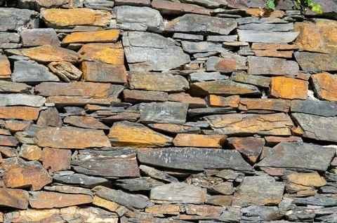 Stone Wall Texture with Irregular Natural Slate Stones for Backgrounds Stock Photos