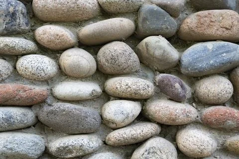 Stone Wall Texture Made of Rounded River Rocks Foto stock