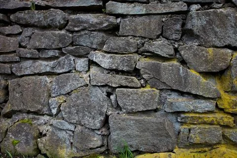 Stone wall texture with moss Stock Photos