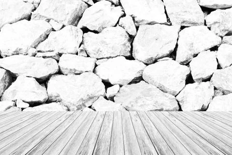 Stone wall texture , process in white color with wood terrace 스톡 사진