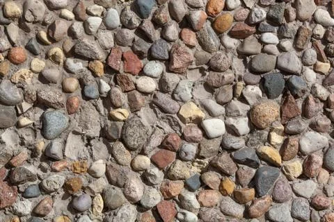 Stone wall texture, road made of small round stones Stock Photos