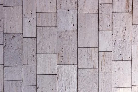 Stone wall texture, square yellow travertine tile. Design element or backgrou Stock Photos