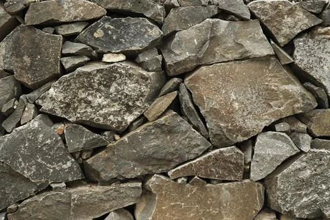 Stone wall, Texture of a stone wall. Stone wall texture background, rock wall Stock Photos