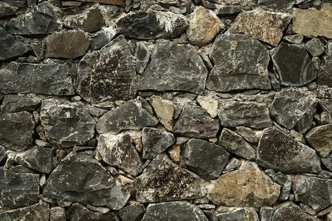 Stone wall, Texture of a stone wall. Stone wall texture background, rock wall Stock Photos
