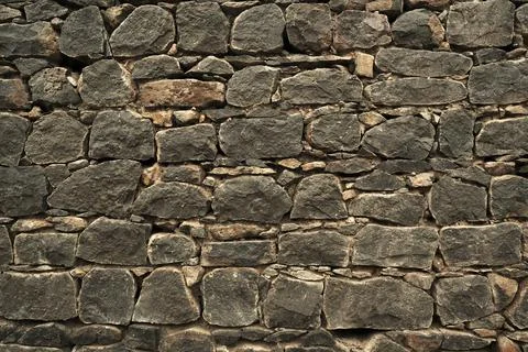 Stone wall, Texture of a stone wall. Stone wall texture background, rock wall Stock Photos