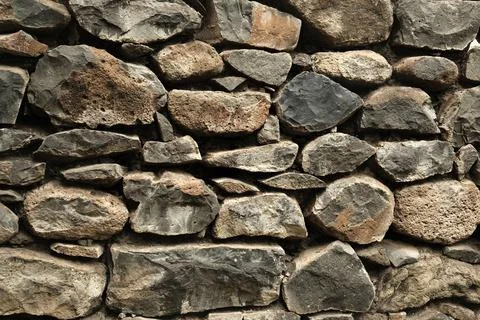 Stone wall, Texture of a stone wall. Stone wall texture background, rock wall Stock Photos