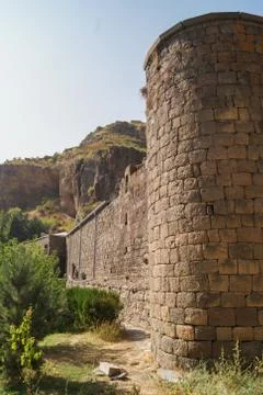 Stone wall with a tower. Stock Photos