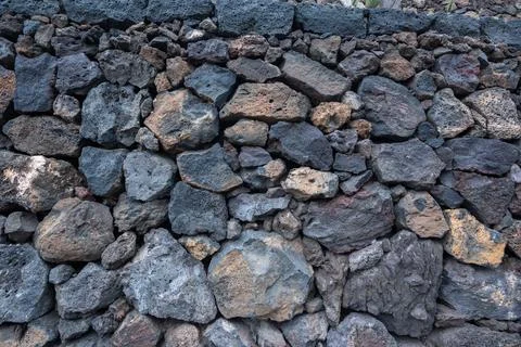 Stone wall, volcanic stone background Stock Photos
