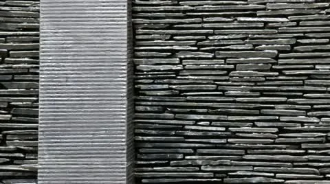 Stone Wall With Waterfall and Vertical Column Stock Footage 12302037