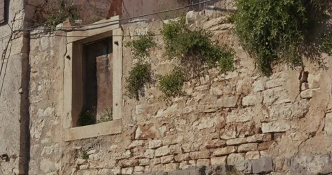 Stone wall with window opening and plants in Bale, Istria Video stock 334032686