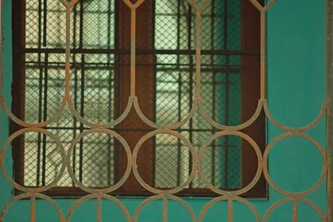 Stone wall with windows, a fragment of the facade , a lattice and a mooring o Stock Photos