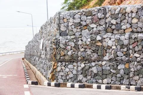 Stone wall with wire mesh Stock Photos