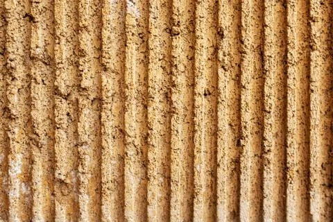 Stone wall with a yellow textured surface. background for the designer Stock Photos