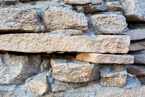 Stone walls, stone background. High quality photo. Rough masonry walls Stock Photos