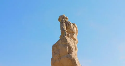 Stone war monument soldier statue against clear blue sky in Peille, France Stock Footage 345337147