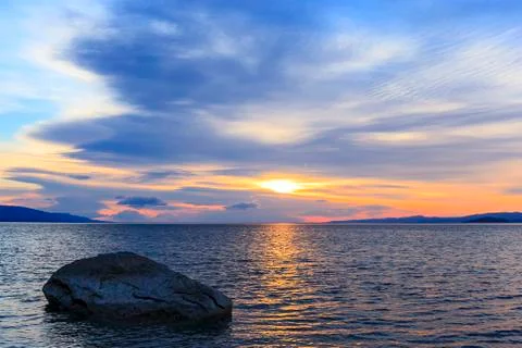 The stone in the water and clouds at dawn Stock Photos