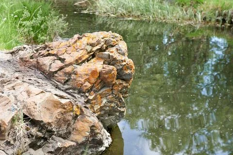 Stone in the water of the river, close-up, background Stock Photos