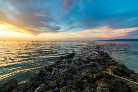 Stone waterbreak at sunset Stock Photos