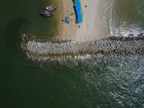 Stone wave breaker into the sea at Map ta phut Industrail Estate, Rayong Stock Footage 77443267