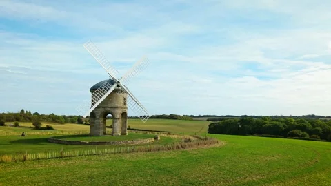 Stone windmill monument overlooking green countryside and farmland. Historic Stock Footage 346811530