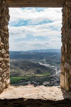 Stone window of a castle through Stock Photos