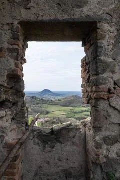 Stone window frame looking out over scenic hills 库存照片