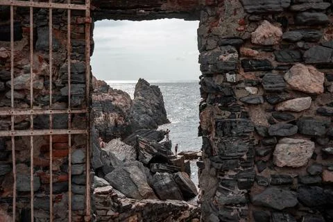Stone window or opening in a stone wall overlooking scenic landscape Stock Photos