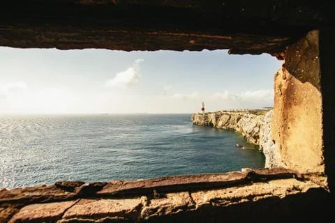 Stone window overlooking ocean beside cliff Stock Photos