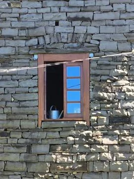 Stone Window with Watering Can Stock Photos