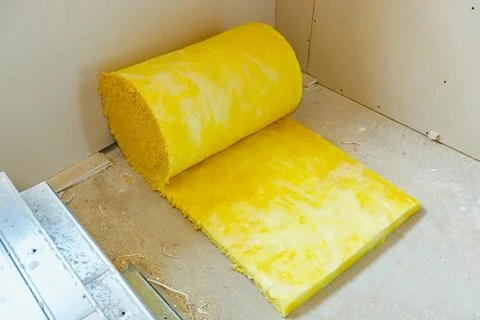 Stone wool roll placed on the floor for installation on the interior walls Stock Photos