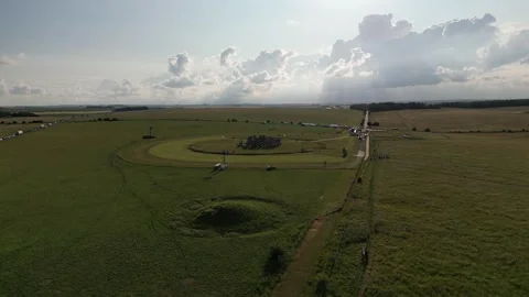 Stonehenge Evening Drone View Gliding over Mound to Stone Circle 4K Stock Footage 245676546