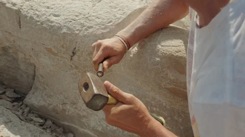 Stonemason Carving Stone Block with Hammer in Piran Stock Footage 341461453