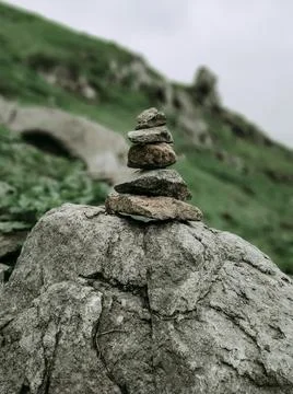 Stones aligned vertically on a rock Photos