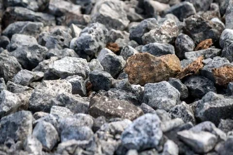 Stones average size mostly dark gray and several red Stock Photos