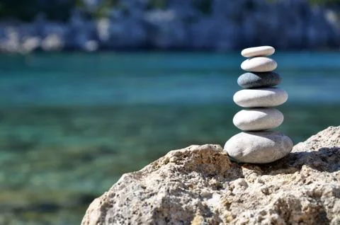 Stones balance on beach. Day and sun. Stock Photos