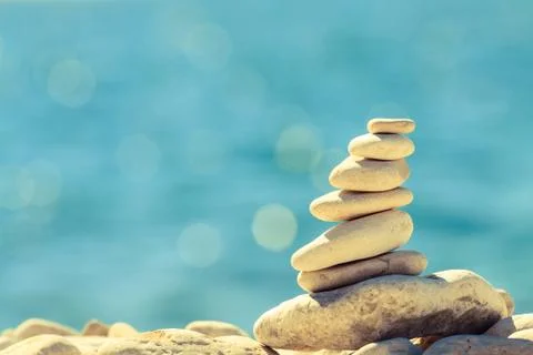 Stones balance at the beach, stack over blue sea Stock-Fotos