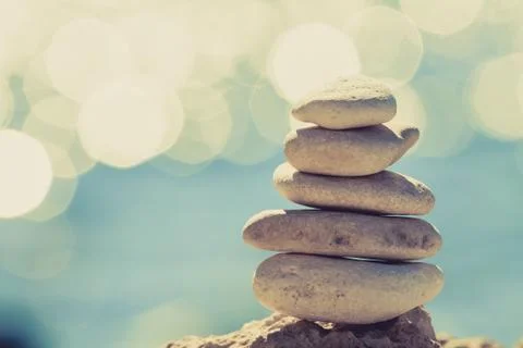 Stones balance at the beach, stack over blue sea Stock Photos