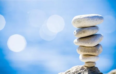 Stones balance, pebbles stack over blue sea in Croatia. Stock Photos