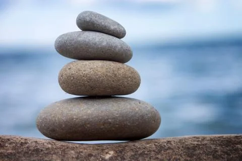 Stones balance, pebbles stack over blue sea in Croatia. Blue sky on sunny Stock Photos