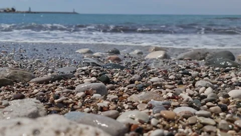 Stones on the beach against the background of the waves Stock Footage 183816107