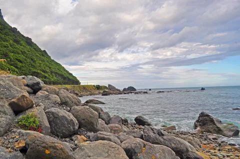 Stones beach with cloudy scene Stock Photos