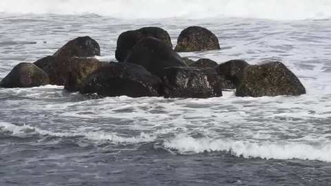 Stones breaking waves on beachline for backgrounds Stock Footage 342291559