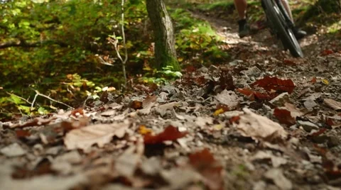 Stones flying towards the camera after mountain bicycle passes in slow motion Stock Footage 44236811