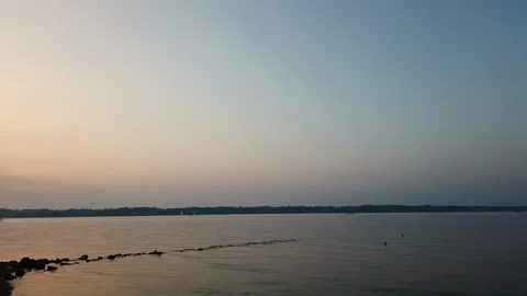 Stones at the ocean. Romantic Sunset with reflection on the water Stock Footage 114950638